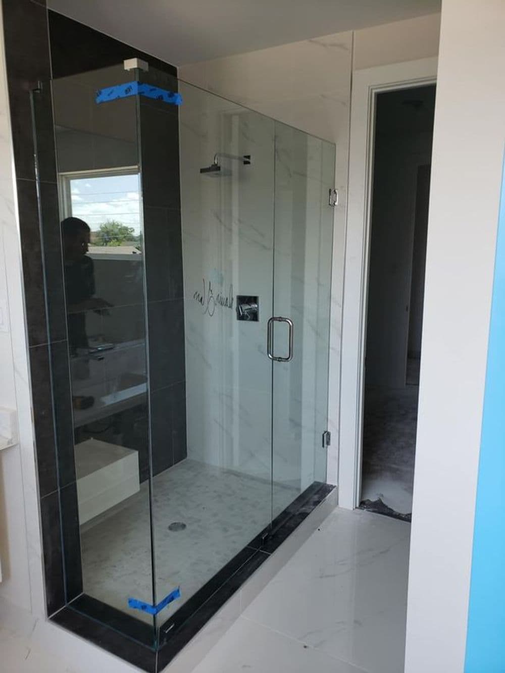 Modern bathroom with a frameless glass shower enclosure and sleek tile design.